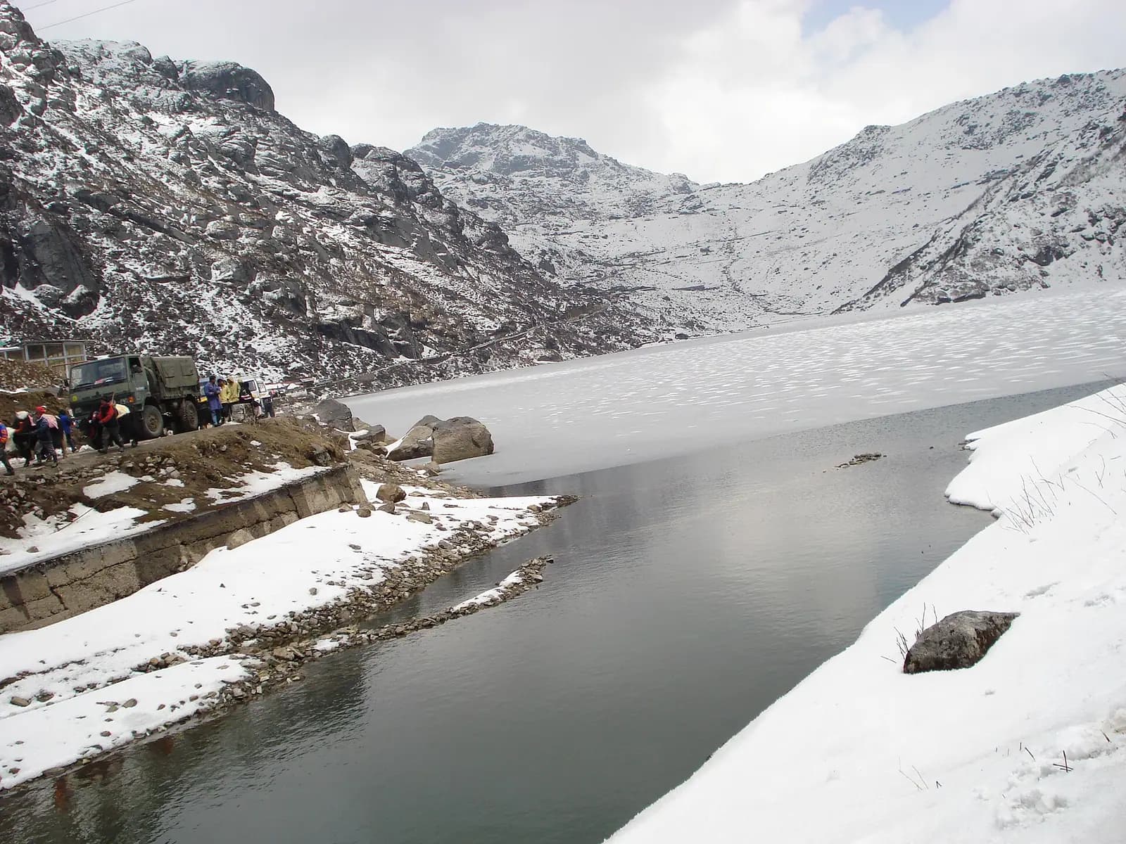 Tsomgo lake held between bare high ridges east of Gangtok, Sikkim