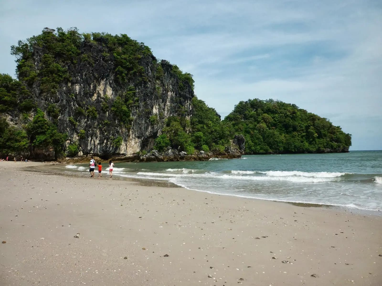 Long-tail boats drawn up on the beach at Ao Nang, Krabi, Thailand