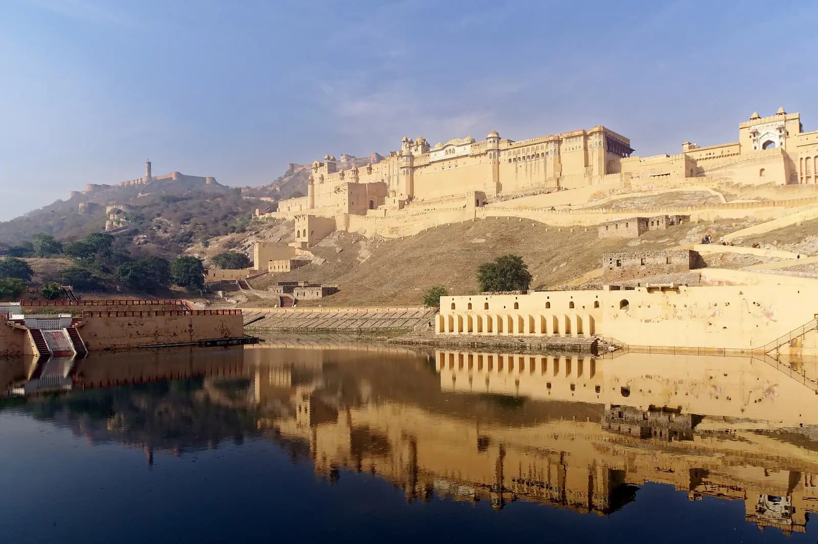 Amber Fort reflected in the still water of Maota lake near Jaipur, Rajasthan